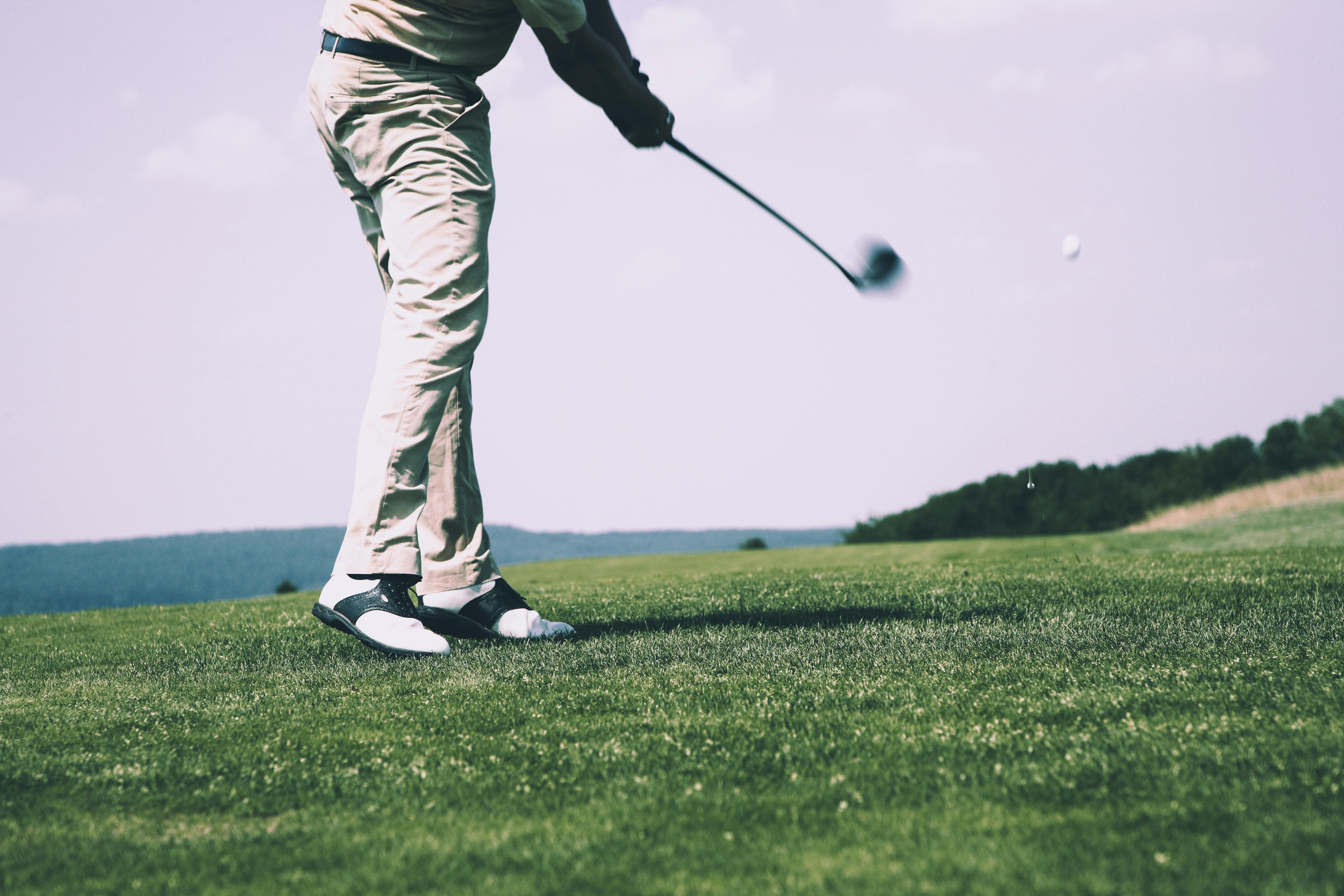 Golfer taking a swing on golf course