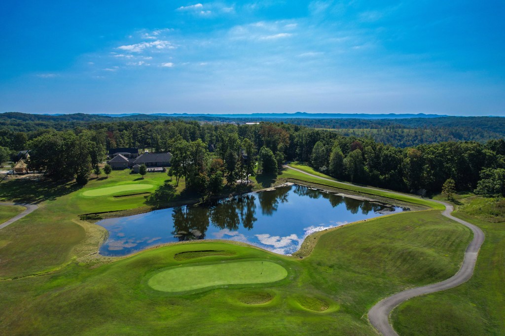 Image of golf ball on tee on grass.